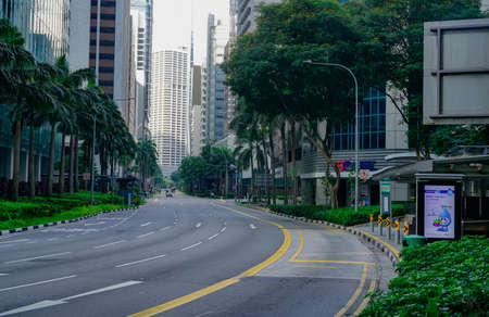 SINGAPORE-MAY 20, 2019 : Quiet asphalt road with green tree and garden beside the road with...