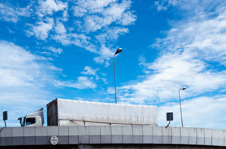 Truck transport logistics. Elevated concrete highway road. Truck with containers on the road delivery goods for export. Truck freight concept. Freight transport by road. Lorry transport cargo.の写真素材