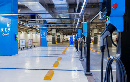 BANGKOK, THAILAND-OCTOBER 22, 2020 : Electric vehicle charger station or EV charging station for charge EV battery at basement floor car parking lot of BITEC Bangna, Thailand. Charging point for EV.のeditorial素材