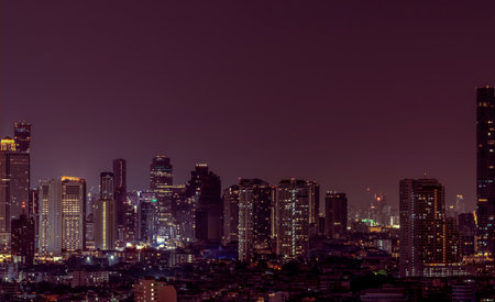 Cityscape of modern building in the night. Modern architecture office building. Skyscraper with beautiful evening sky. Business and financial center building. Apartment in the city with night light.の写真素材