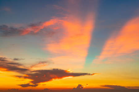 Beautiful sunset sky. Orange and blue sunset sky with beautiful pattern of clouds. Orange, red, and...