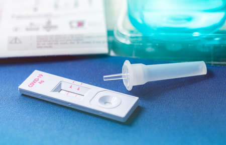 Covid 19 antigen self test for nasal swab with positive result. Antigen test kit for home use to...