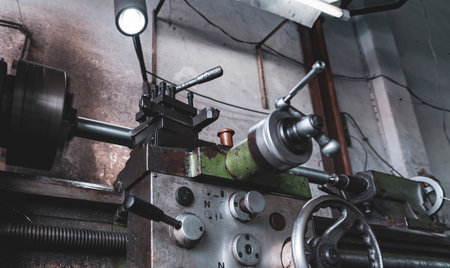 Old lathe machine in factory. Lathe turning machine for metalwork. Heavy machinery manufacturing....