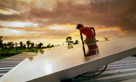 Man checking solar panel on roof for safety. Solar panel or photovoltaic module maintenance....