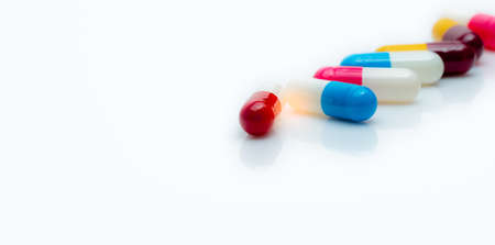 Selective focus on antibiotic capsule pills on white background. Pharmacy horizontal web banner....