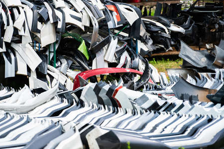Pile of used front bumper, rear bumper, and spoiler of car for recycle. Carbon fiber, PU and PP...