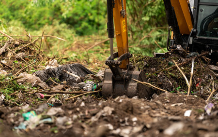 Backhoe digging soil at construction site. Bucket of backhoe digging soil. Clearing and grubbing....