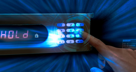 Finger pressing password code on safe box to open metal safe in hotel. Cyber security and data...