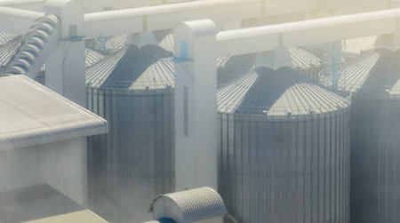 Animal feed factory. Agricultural silo at feed mill factory. Tank for store grain, corn, soybean in feed manufacturing. Seed stock tower for commercial animal feed production. Animal food industry.の写真素材