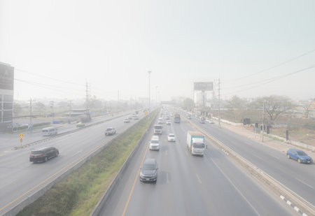 PATHUM THANI, THAILAND-MARCH 10, 2023: Cars driving on highway road with air pollution. Smog and...