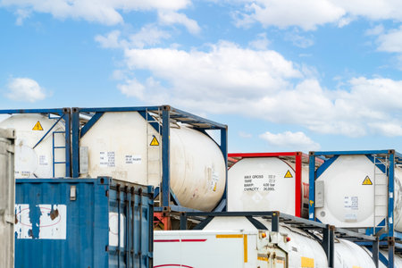 Chemical tank container. ISO tank container for chemical delivery. Bulk liquid transport. Chemical company. Container freight area. Global logistics business. Chemical container for truck transport.の写真素材