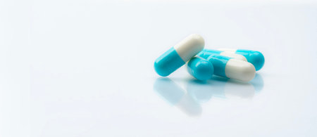 Blue-white capsule pills on white background. Pharmacy banner. Prescription drug. Healthcare and...