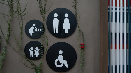 Public toilet sign. Woman, men, children, baby diaper changing, and disabled person toilet icon on restroom wall. Public restroom universal icon. Disabled access symbol. Latrine or WC. Washroom sign.の写真素材