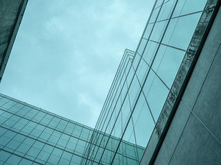 Modern sustainable green glass office building. Exterior view of corporate headquarters glass building architecture. Energy-efficient building. Financial business center. Glass windows of company.の写真素材