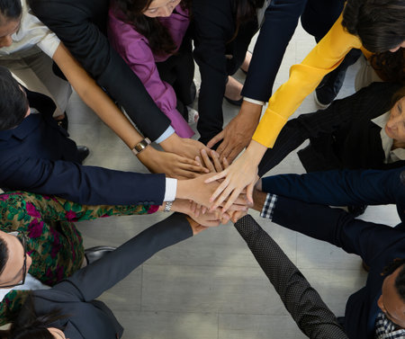 Team, teamwork, and unity concept. Diverse team putting hands together. Group of diverse business...