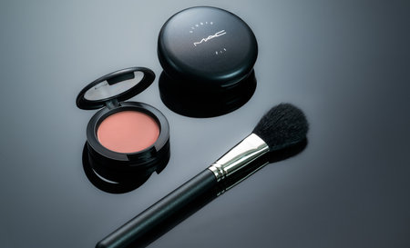 CHONBURI, THAILAND-DECEMBER 14, 2022: MAC studio fix powder plus foundation, powder blush, and makeup brush on black background. Cosmetic products. Makeup professionals cosmetics. Beauty fashion.のeditorial素材