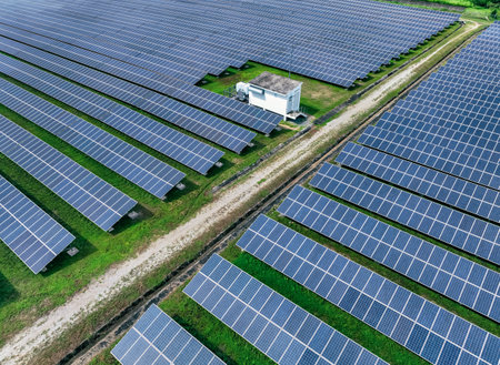 Aerial view of solar farm. Solar power for green energy. Sustainable resources. Solar cell panels use sun light as a source to generate electricity. Photovoltaics or PV. Sustainable renewable energy.の写真素材