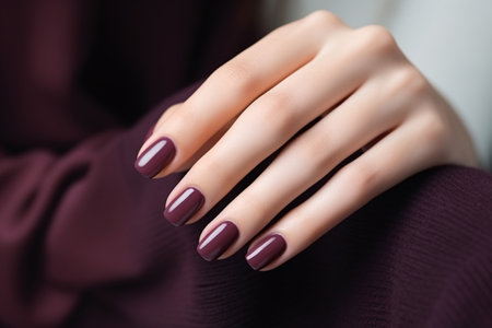 Glamour woman hand with deep berry and plum nail polish on fingernails. Nail manicure with gel polish at luxury beauty salon. Nail art and design. Female hand model. French manicure. Generative AI.の素材