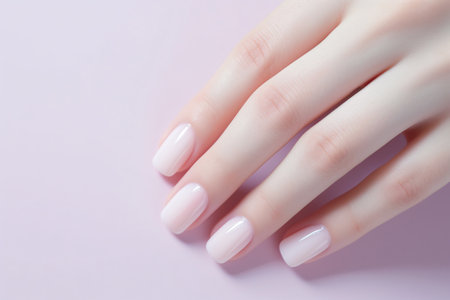 Glamour woman hand with light pink nail polish on her fingernails. Pink nail manicure with gel polish at luxury beauty salon. Nail art and design. Female hand model. French manicure. Generative AI.の素材