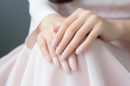 Glamour woman hand with light pink nail polish on her fingernails. Pink nail manicure with gel polish at luxury beauty salon. Nail art and design. Female hand model. French manicure. Generative AI.の素材