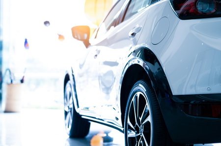 Rearview car parked in luxury showroom. Car dealership office. New car parked in modern showroom. Car for sale and rent business concept. Automobile leasing and insurance concept. Electric automobile.の写真素材