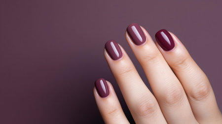 Woman hand with burgundy color nail polish on her fingernails. Burgundy nail manicure with gel polish at luxury beauty salon. Nail art and design. Female hand model. French manicure. Generative AI.の素材