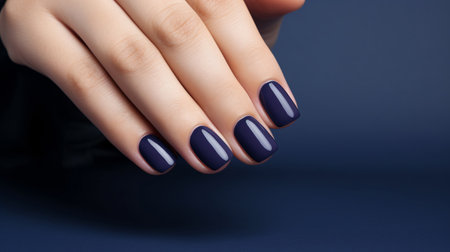 Glamour woman hand with navy blue nail polish on her fingernails. Navy nail manicure with gel polish at luxury beauty salon. Nail art and design. Female hand model. French manicure. Generative AI.の素材
