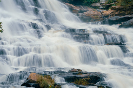 Beautiful waterfall in lush tropical forest, Chiang Mai, Thailand. Nature landscape. Long exposure of water falling on rock of mountainside. A waterfall flows on mountainside. World Water Day concept.の写真素材