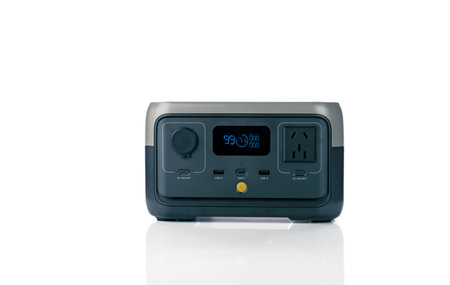 Portable power station or power box isolated on white background. On-the-Go energy solution. Power supply for outdoor adventure. Compact portable power box with a rechargeable lithium-ion battery.の写真素材
