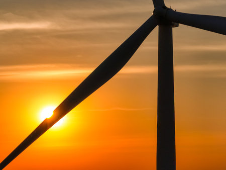 Wind farm field and sunset sky. Wind power. Sustainable, renewable energy. Wind turbines generate electricity. Sustainable development. Green technology for energy sustainability. Eco-friendly energy.の写真素材