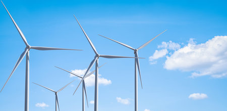 A group of wind turbines against blue sky, Wind energy. Wind power. Sustainable, renewable energy. Wind turbine generate electricity. Sustainable resources. Green technology for energy sustainability.の写真素材