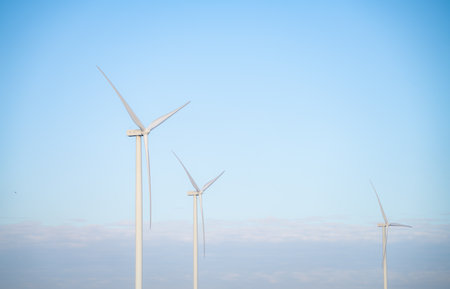 Wind energy and sustainable power generation with wind turbines, Eco-friendly solutions for renewable resources. Wind power farm and sustainable development of renewable energy, green technology.の写真素材