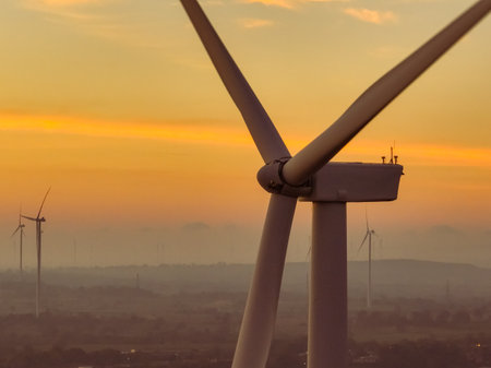 Wind farm field and sunset sky. Wind power. Sustainable, renewable energy. Wind turbines generate electricity. Sustainable development. Green technology for energy sustainability. Eco-friendly energy.の写真素材