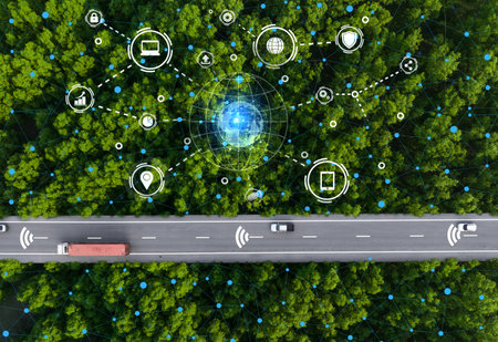 Aerial top view driverless car and hydrogen-powered truck cruising along green forest highway. Future of sustainable transport with electric vehicles and renewable energy in eco-friendly environment.の写真素材