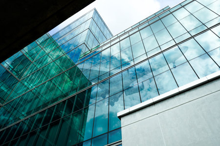 Modern glass office building. Sustainable office tower. Corporate headquarters in financial district. Green architecture. Energy-efficient skyscraper. Future of urban development and financial hubs.の写真素材