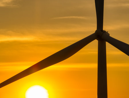 Wind farm field and sunset sky. Wind power. Sustainable, renewable energy. Wind turbines generate electricity. Sustainable development. Green technology for energy sustainability. Eco-friendly energy.の写真素材