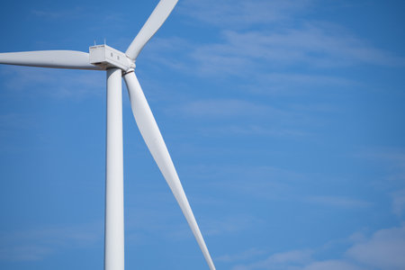 Wind turbines against blue sky, Wind energy. Wind power. Sustainable, renewable energy. Wind turbine generate electricity. Sustainable resources. Green technology for energy sustainability.の写真素材