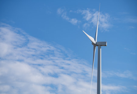 Wind turbines against blue sky, Wind energy. Wind power. Sustainable, renewable energy. Wind turbine generate electricity. Sustainable resources. Green technology for energy sustainability.の写真素材