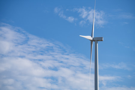 Wind turbines against blue sky, Wind energy. Wind power. Sustainable, renewable energy. Wind turbine generate electricity. Sustainable resources. Green technology for energy sustainability.の写真素材