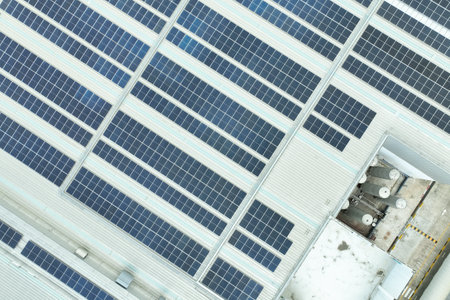 Solar energy for factory and warehouse building. Solar panels on roof of industrial plant....