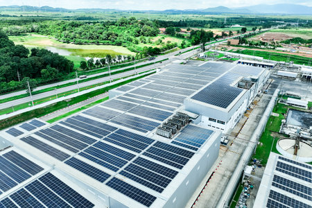 Solar energy for factory and warehouse building. Solar panels on roof of industrial plant. Commercial solar power. Rooftop solar power. Rooftop renewable energy system. Sustainable green energy.の写真素材