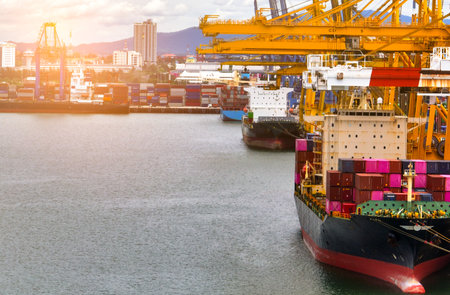 Logistics and transportation of container cargo ship at ship port. Container truck and crane bridge in shipyard. Import export and transport industry. Terminal port for export transport by ship.の写真素材
