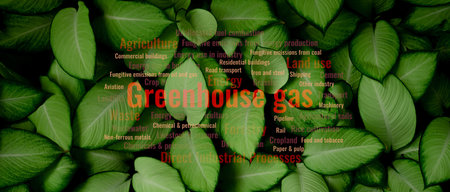 Greenhouse gas emissions from agriculture and industrial activity releasing air pollution into the atmosphere, with leaf background symbolizing environmental impact and global climate awareness.の写真素材
