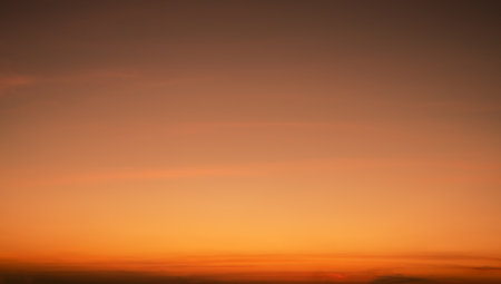 Calming orange sunset glows above peaceful horizon in summer. Peaceful sky at dusk create serene atmosphere for relaxation meditation background nature landscape scenic view summer evening tranquilityの写真素材