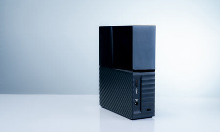 Black solid state external hard drive on white background, perfect for digital data storage and fast...