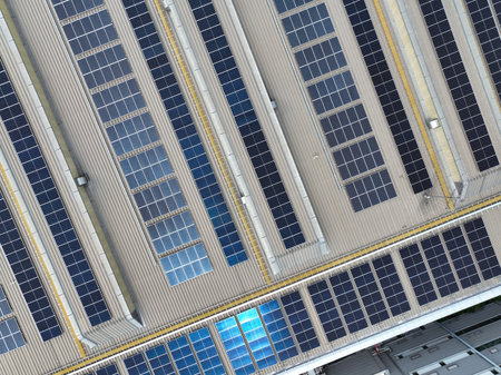 Solar-powered warehouse facility. Modern distribution center with rooftop solar panel. Eco-friendly warehouse. Sustainable logistics solutions for reduced carbon footprint. Sustainable energy.の写真素材