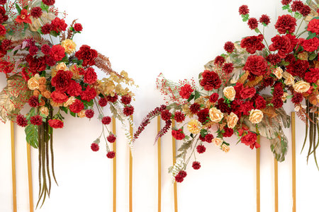 Red flower bouquet with yellow accents arranged as graduation celebration gift for students achieving academic success at university commencement ceremony milestone. Celebration party decorations.の写真素材
