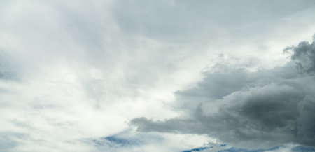 Dramatic overcast sky panorama with gray storm clouds during rainy season. Moody atmospheric background perfect for weather forecasting and emotional storytelling. Climate change awareness.の写真素材