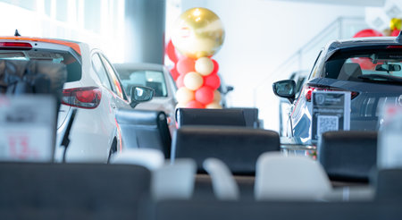Car parked in luxury showroom. Car dealership office. Car showroom business. New car parked in modern showroom. Auto for sale and rent business. Automobile leasing and insurance. Electric automobile.の写真素材