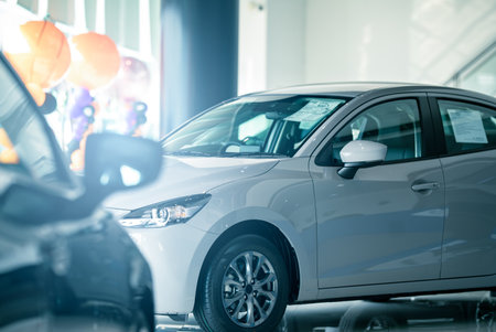 Car parked in luxury showroom. Car dealership office. Car showroom business. New car parked in modern showroom. Auto for sale and rent business. Automobile leasing and insurance. Electric automobile.の写真素材